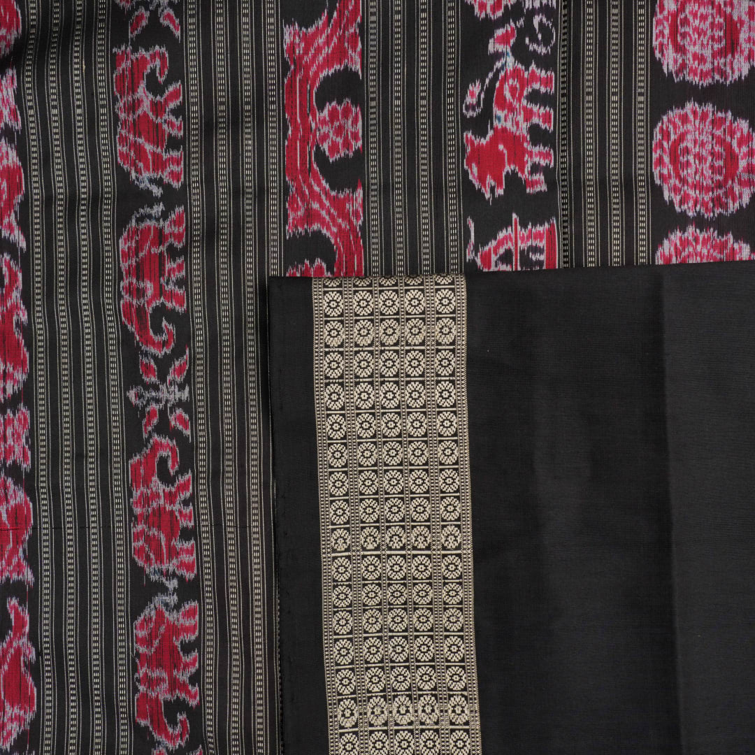 Detailed close-up of the maroon and black Sambalpuri silk saree's luxurious fabric texture and weave.