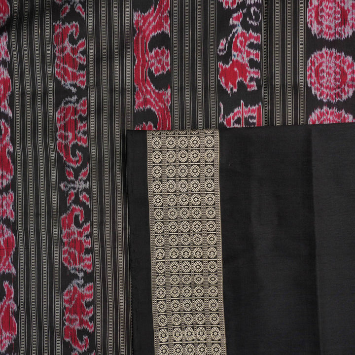 Detailed close-up of the maroon and black Sambalpuri silk saree's luxurious fabric texture and weave.