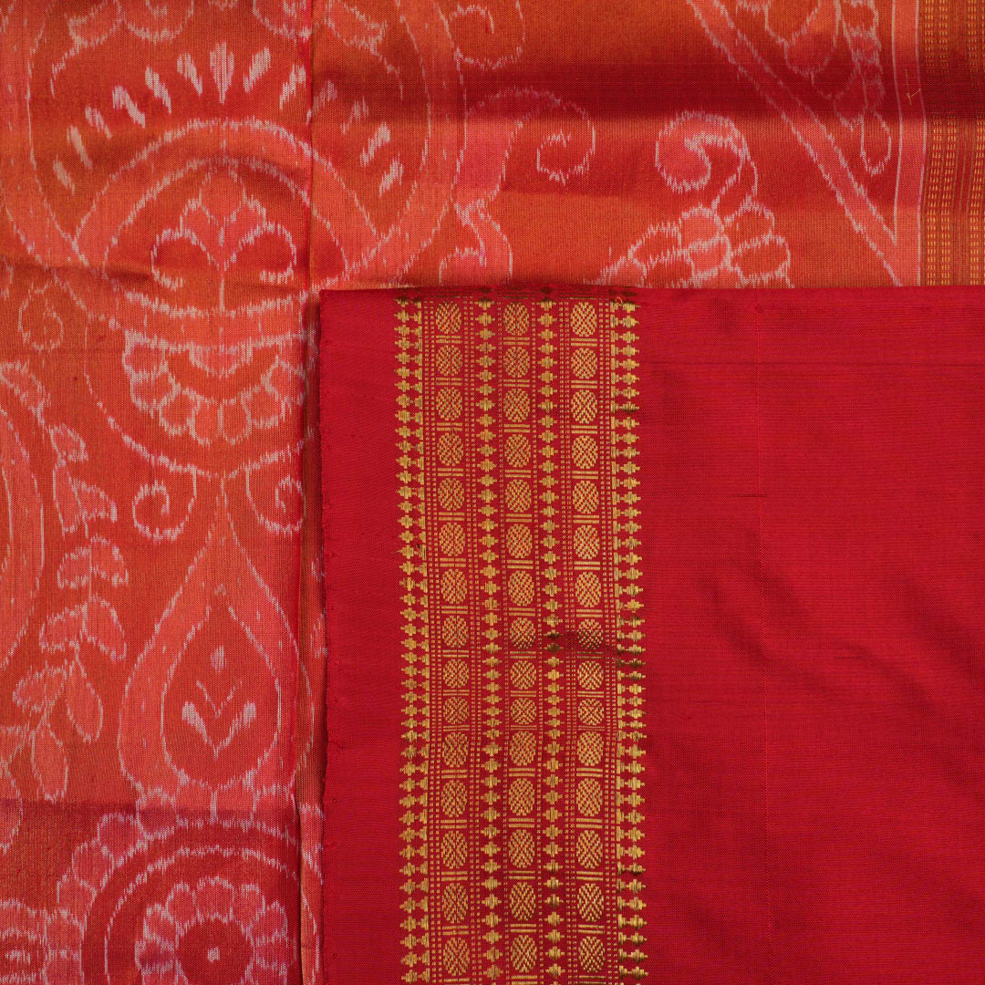 Close-up of rust Sambalpuri silk fabric, revealing its luxurious texture and fine handloom weave.
