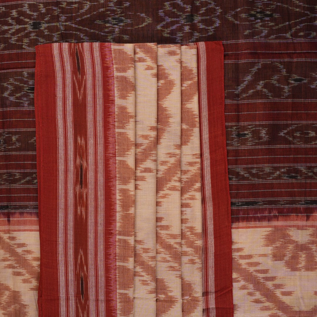 Traditional styling of a cream and rust Sambalpuri cotton saree draped on a model for a classic look.