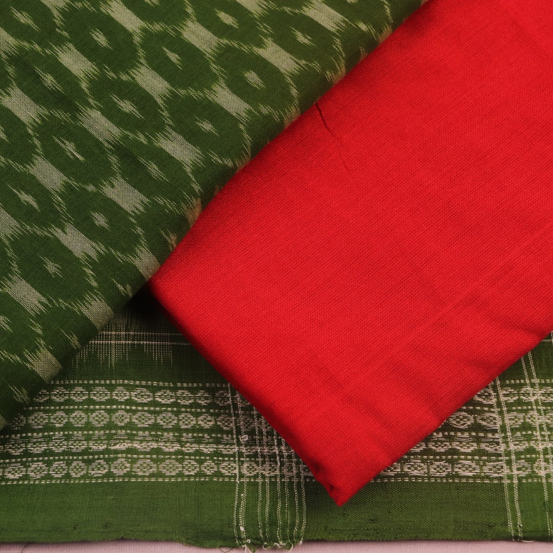 Close-up of the green Sambalpuri cotton dress material's blouse piece with red motifs.