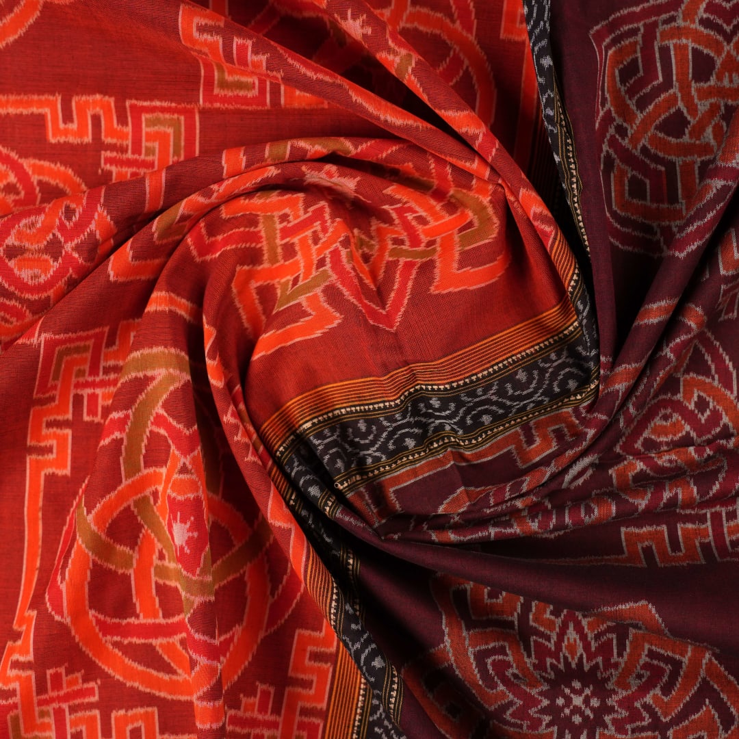 Full flat layout of the orange and black Sambalpuri cotton saree showing the body, border, and pallu