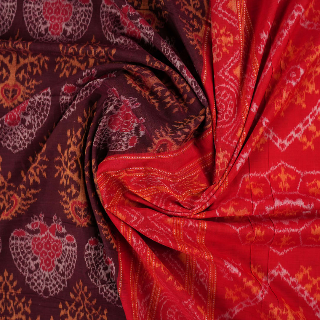 Full layout of a maroon and red Sambalpuri cotton saree displaying the complete body motifs and border.