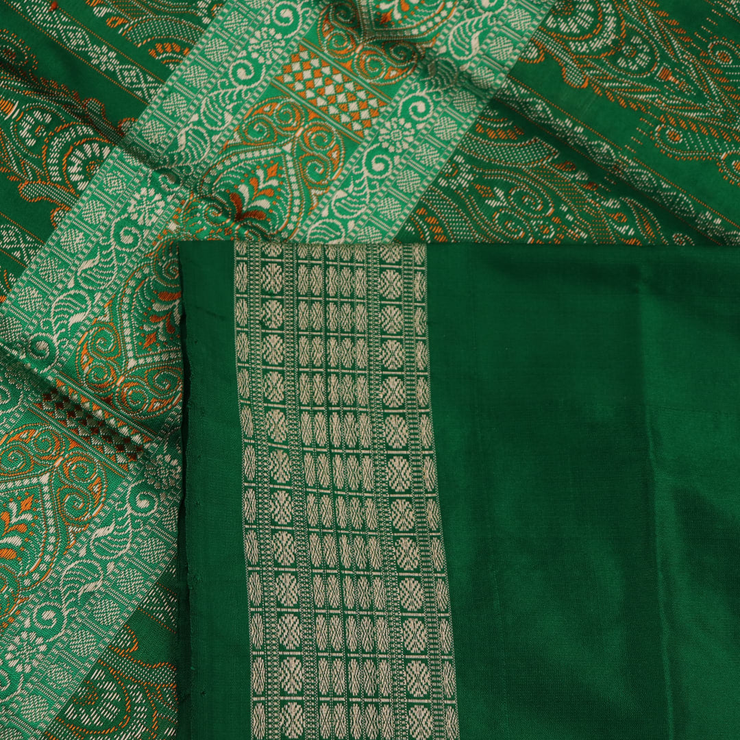 Close-up view of black silk Bomkai saree, showcasing intricate butta patterns and green accents