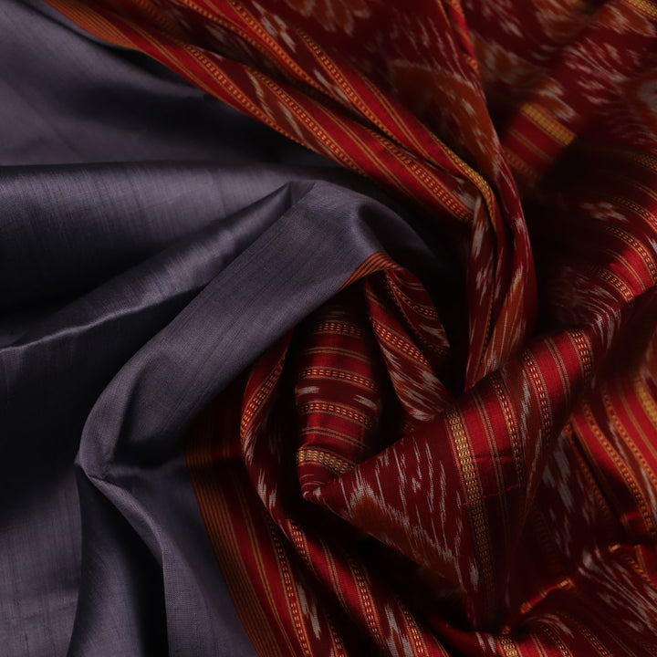 Grey Khandua silk saree styled and draped, showcasing the plain body and red border.