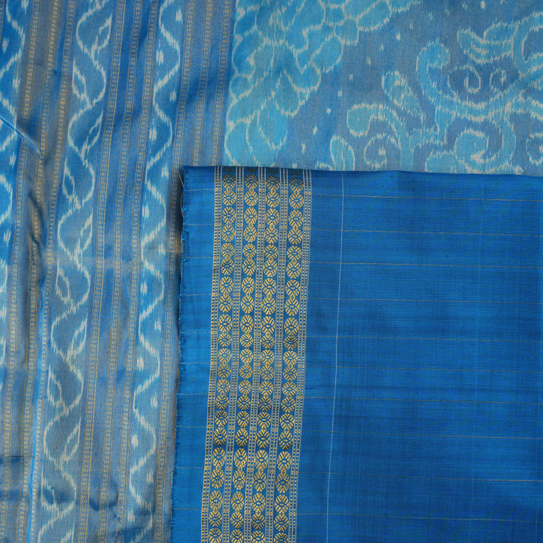 Close-up of Sambalpuri silk saree fabric, revealing rich blue multi-color weave texture and tissue motifs.
