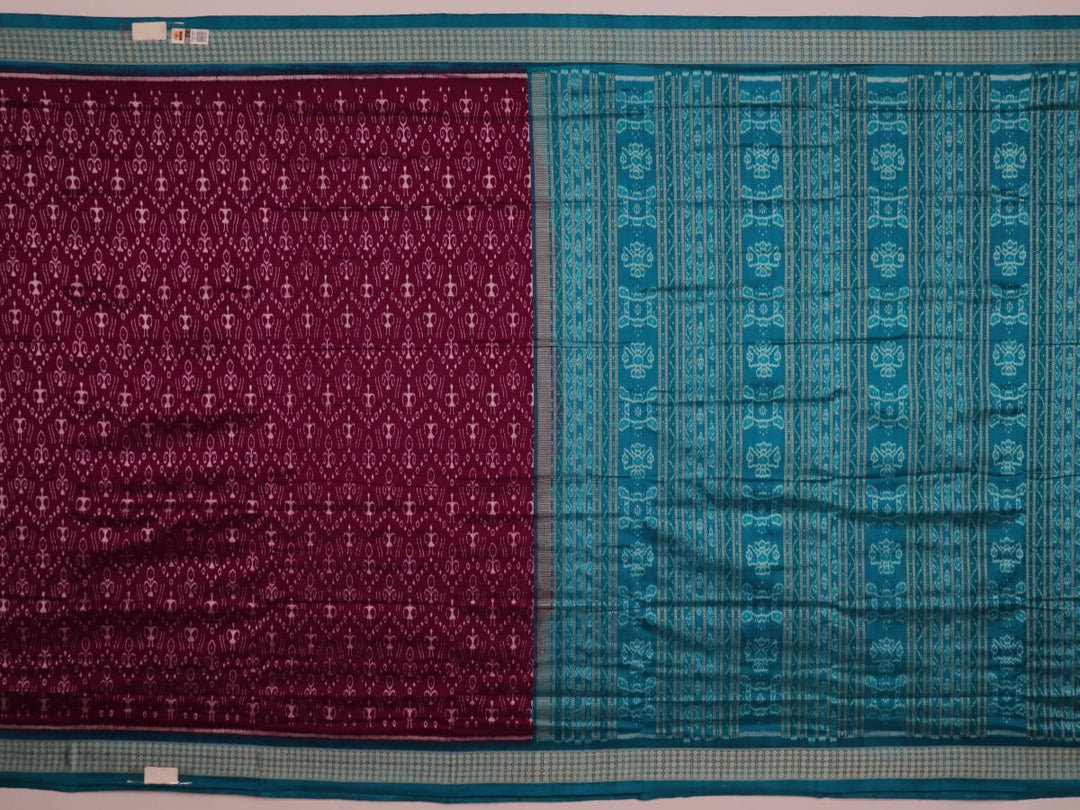 Close-up showcasing the purple and blue silk fabric texture of the Sambalpuri saree with intricate motifs.