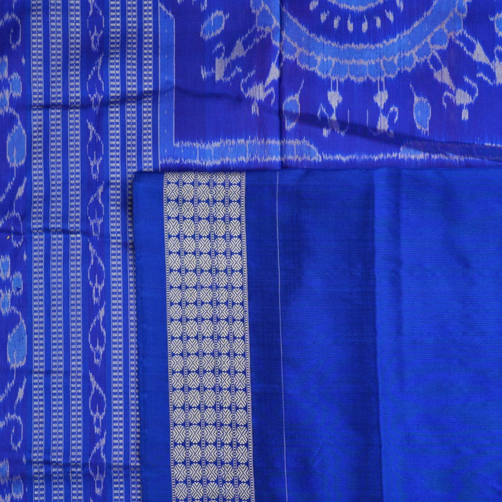 Close-up of Sambalpuri silk fabric texture, revealing the fine handloom weave and quality.