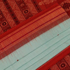 Full view of a handloom green and rust Bomkai cotton saree with butta pattern.