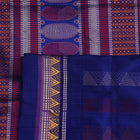 Close-up of pink and blue Dongria Silk Saree fabric texture with butta pattern.
