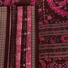 Close-up of peach and maroon Sambalpuri silk saree fabric showing intricate handloom texture and motifs.