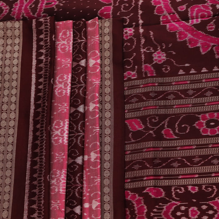 Close-up of peach and maroon Sambalpuri silk saree fabric showing intricate handloom texture and motifs.