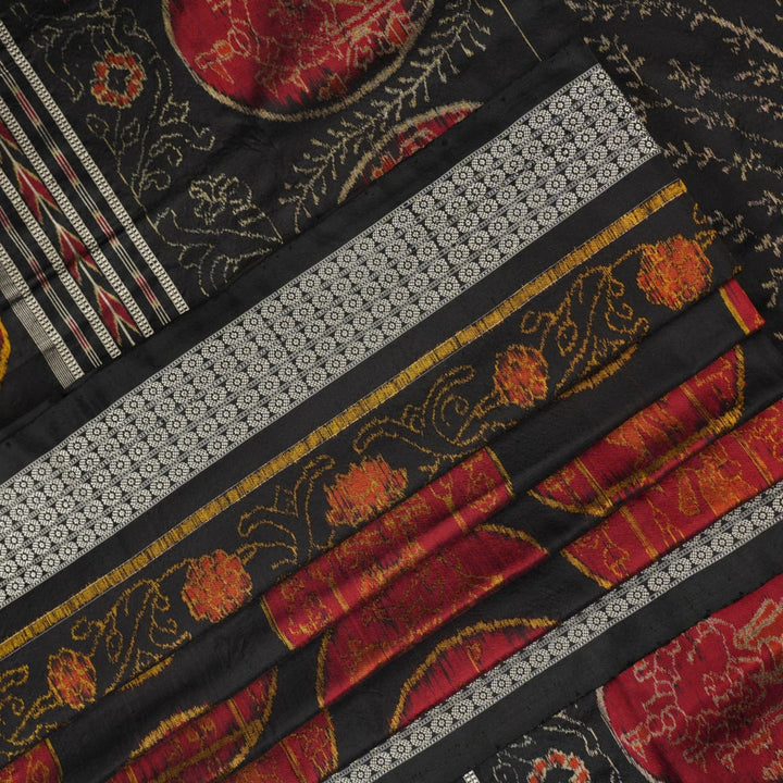 Close-up of the luxurious black Sambalpuri silk fabric, highlighting its rich texture and weave.