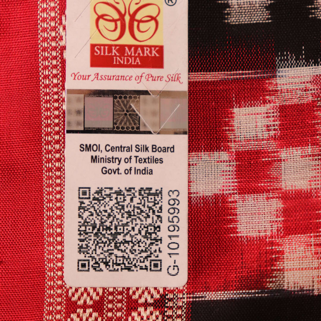 Close-up of black and red silk saree fabric with intricate Sambalpuri motifs