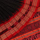 Close-up of black and red striped Sambalpuri silk saree's woven texture.