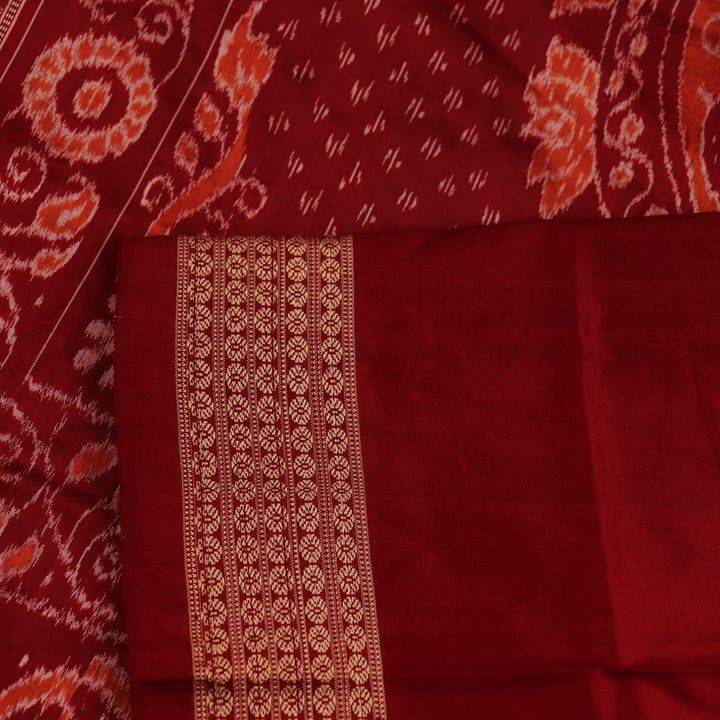 Close-up showcasing the intricate cream and maroon silk fabric texture with Sambalpuri motifs