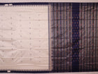 Close-up of white and blue Sambalpuri Silk Saree fabric texture, highlighting butta pattern.