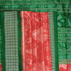 Close-up of the smooth, rich silk texture of the peach Sambalpuri saree with fine motifs.