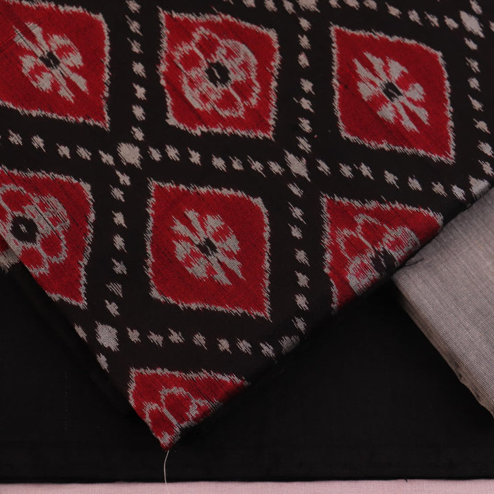 Detail of black and grey Sambalpuri Silk Dress Material blouse piece with motifs.