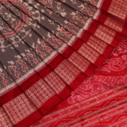 Close-up of grey Sambalpuri silk saree fabric showing intricate motif texture.