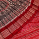 Close-up of grey Sambalpuri silk saree fabric showing intricate motif texture.