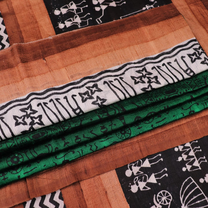 Full view of a green and brown Tussar silk saree featuring traditional motifs throughout the body.