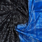 Close-up of Sambalpuri Silk saree fabric, revealing its rich texture and intricate black and blue weave.