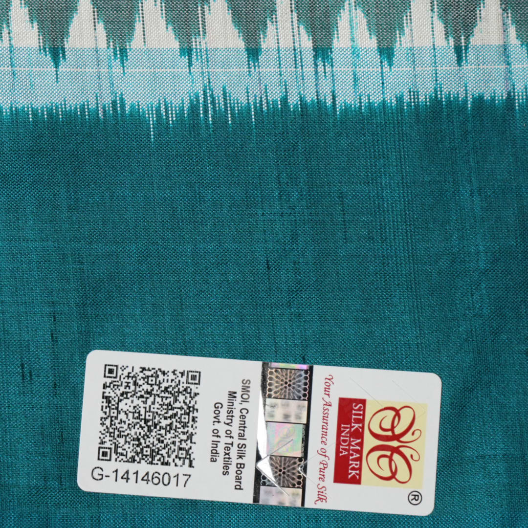 Close-up revealing the luxurious silk texture and subtle motif weave of the blue Sambalpuri saree.