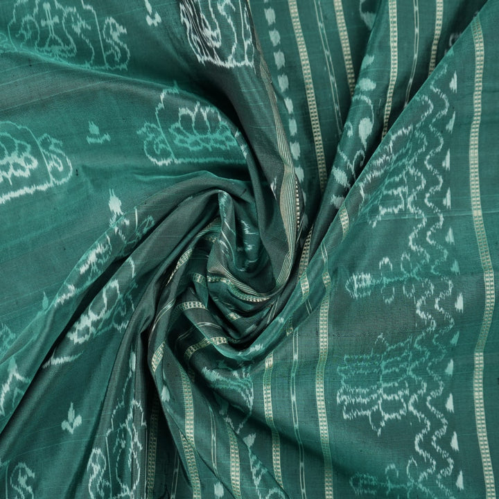 Close-up of green Sambalpuri silk fabric, showing its luxurious texture and fine handloom weave.
