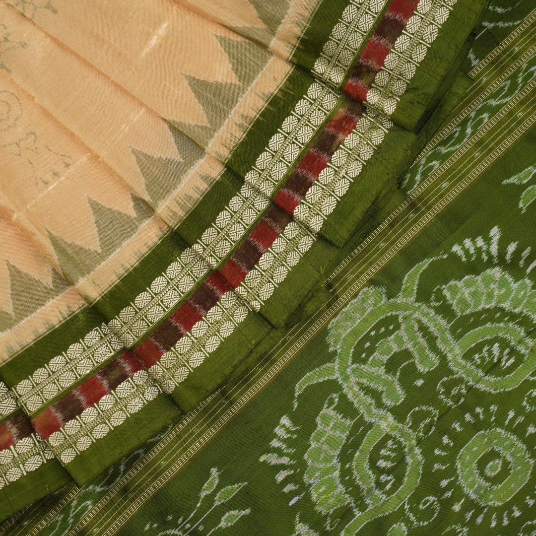 Extreme close-up of cream Sambalpuri silk saree showing exquisite handloom weave texture.