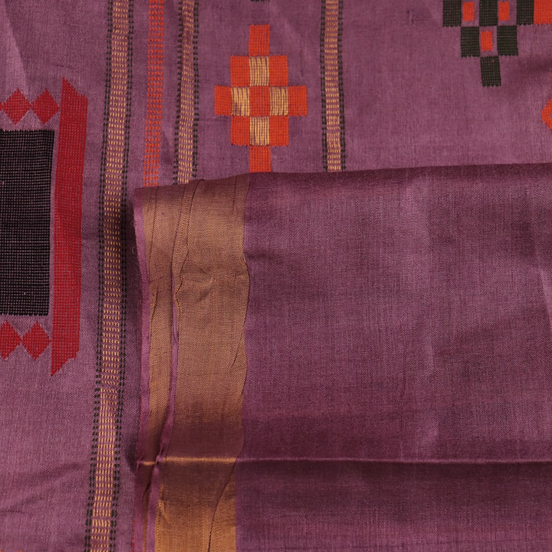 Close-up view of the textured Tussar silk fabric of the saree