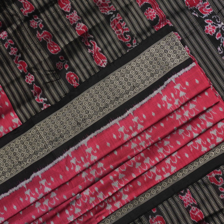 Detailed close-up of the maroon and black Sambalpuri silk saree's luxurious fabric texture and weave.