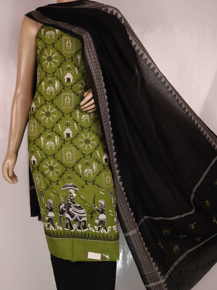 Close-up showcasing the Sambalpuri doll pattern on the green cotton dress material.