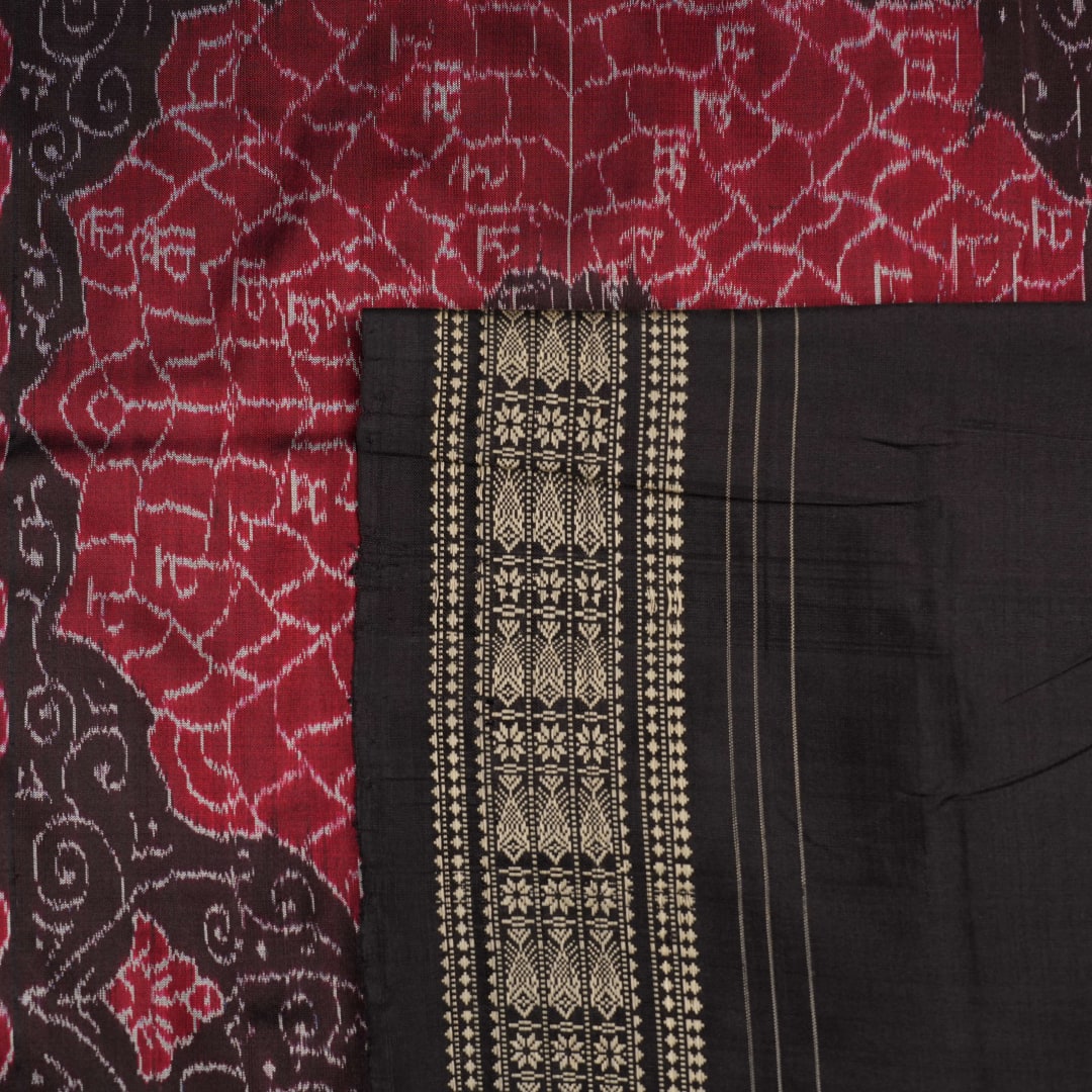 Extreme close-up of black Sambalpuri silk saree fabric, highlighting its luxurious texture and weave.