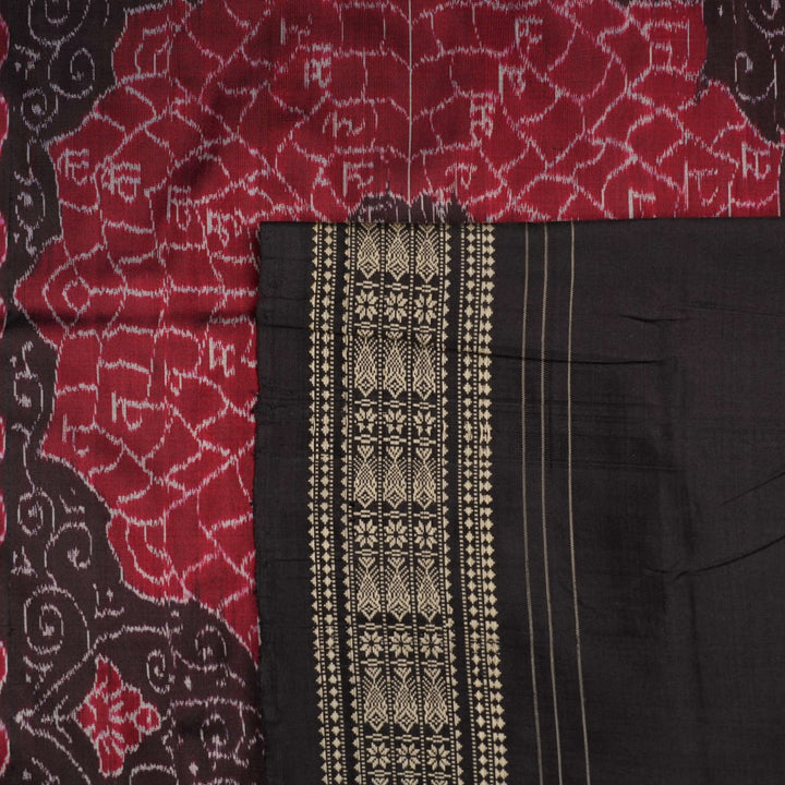 Extreme close-up of black Sambalpuri silk saree fabric, highlighting its luxurious texture and weave.