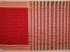 Full body view of a vibrant red cotton Sambalpuri saree featuring intricate butta patterns and a cream border.