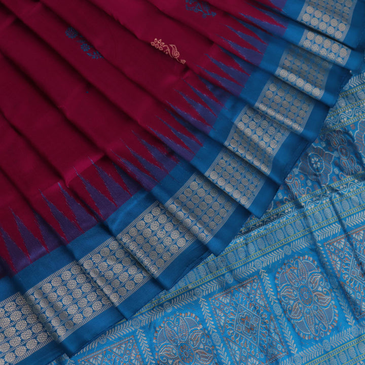 Close-up of Bomkai silk saree's textured weave, featuring magenta, blue, and butta pattern.