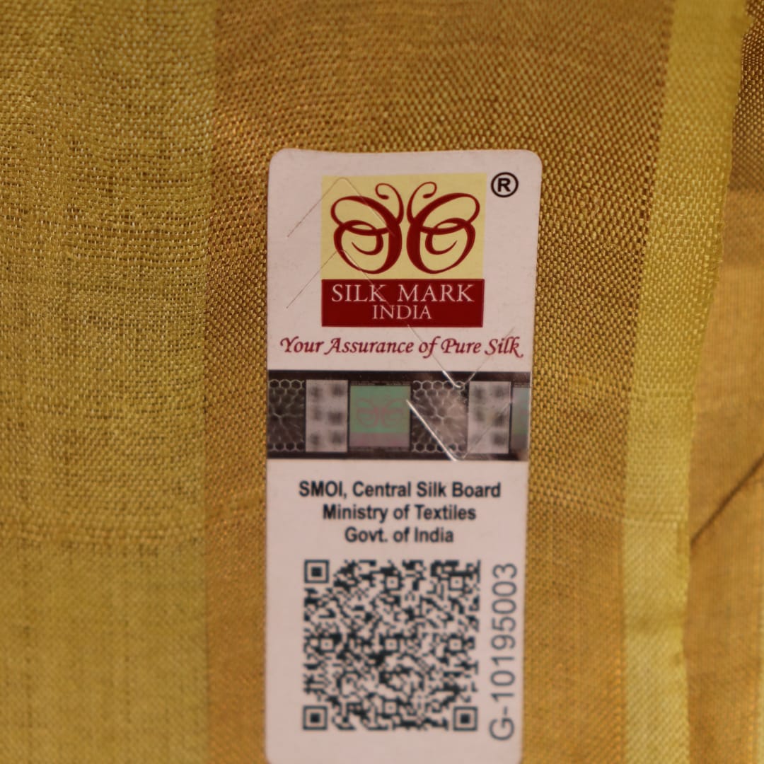 Close-up of yellow Tussar silk saree fabric with intricate butta patterns