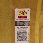 Close-up of yellow Tussar silk saree fabric with intricate butta patterns