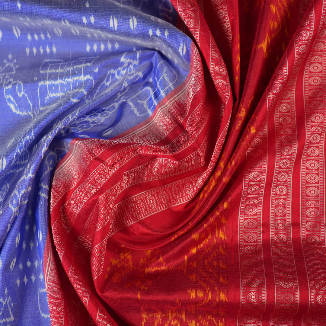Close-up of the luxurious silk texture of the violet and maroon Sambalpuri Saree fabric.