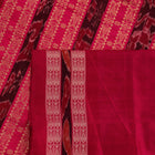 Close-up view of the soft silk fabric texture of a green and magenta Sambalpuri saree with intricate butta patterns