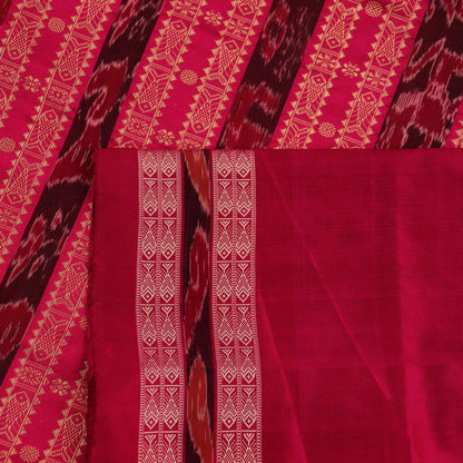 Close-up view of the soft silk fabric texture of a green and magenta Sambalpuri saree with intricate butta patterns