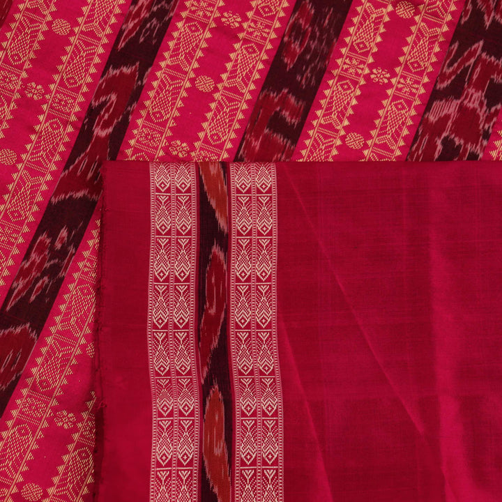 Close-up view of the soft silk fabric texture of a green and magenta Sambalpuri saree with intricate butta patterns