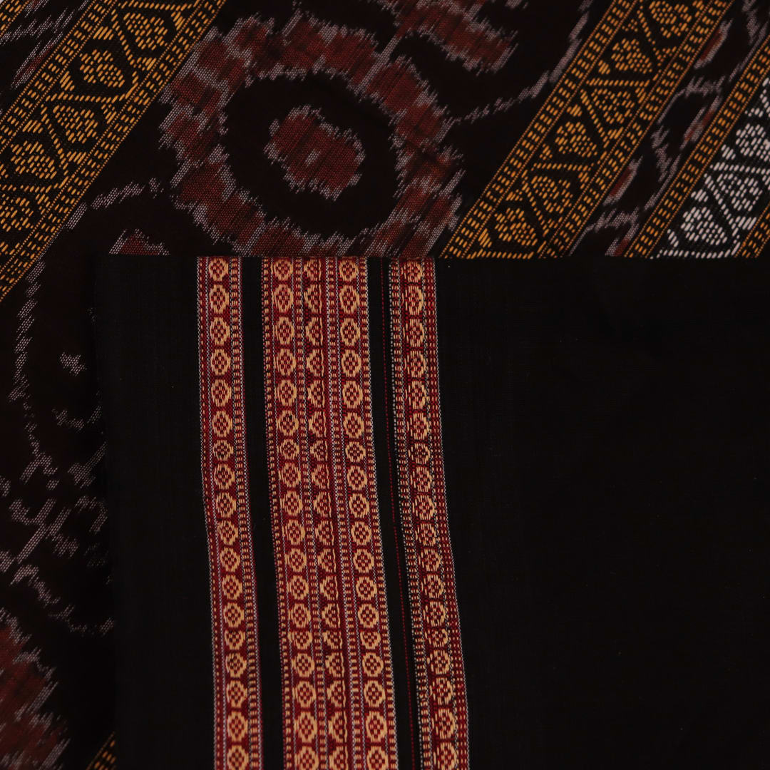 A full-length view of a vibrant magenta cotton Bomkai saree adorned with intricate black motifs.