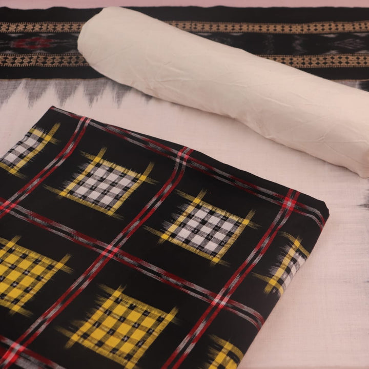 Detail of the black and white Sambalpuri cotton dress material's blouse piece with motifs.