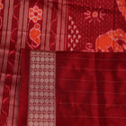 Close-up of multicolored Sambalpuri silk saree fabric texture showing intricate weave and maroon accents.