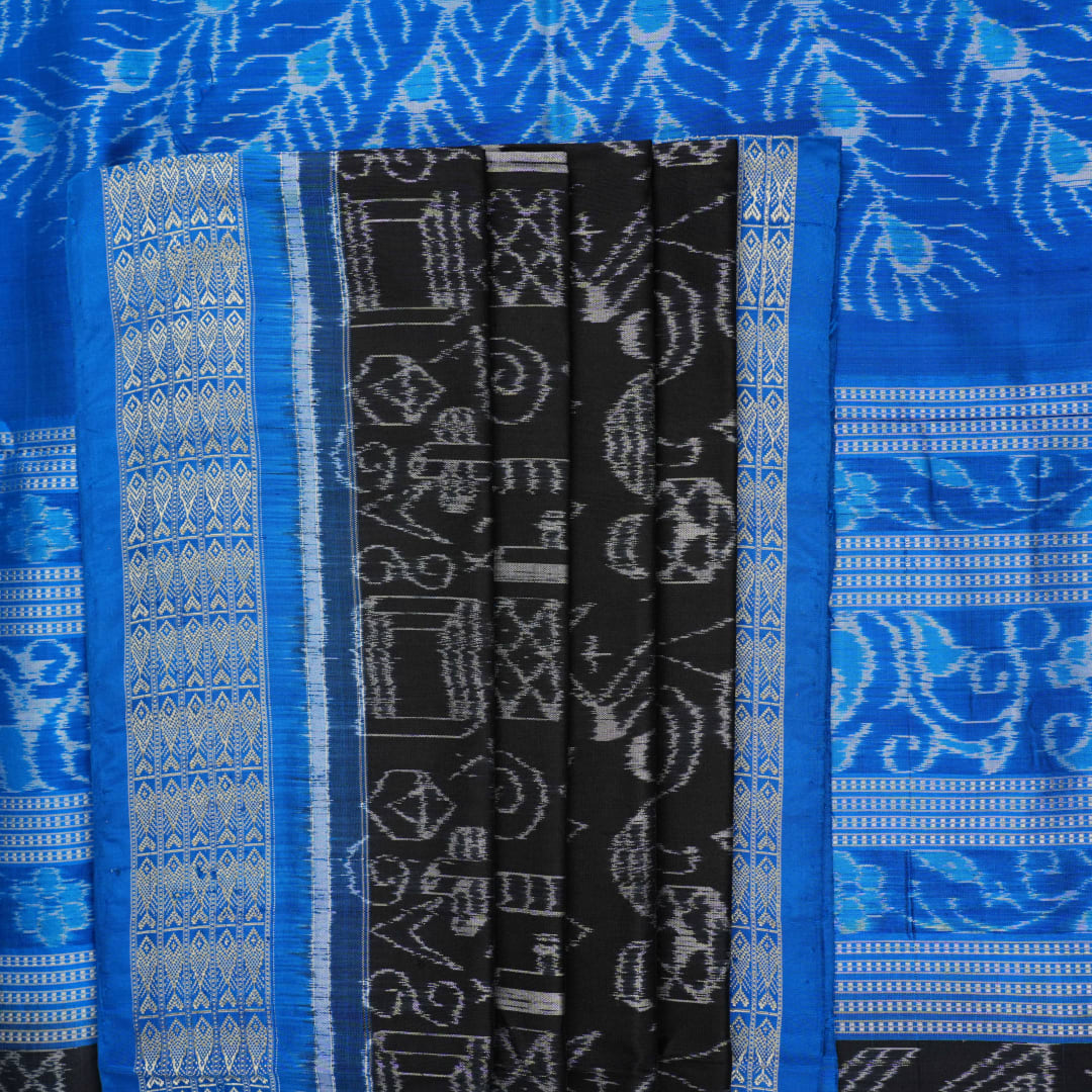 Close-up of Sambalpuri Silk saree fabric, revealing its rich texture and intricate black and blue weave.