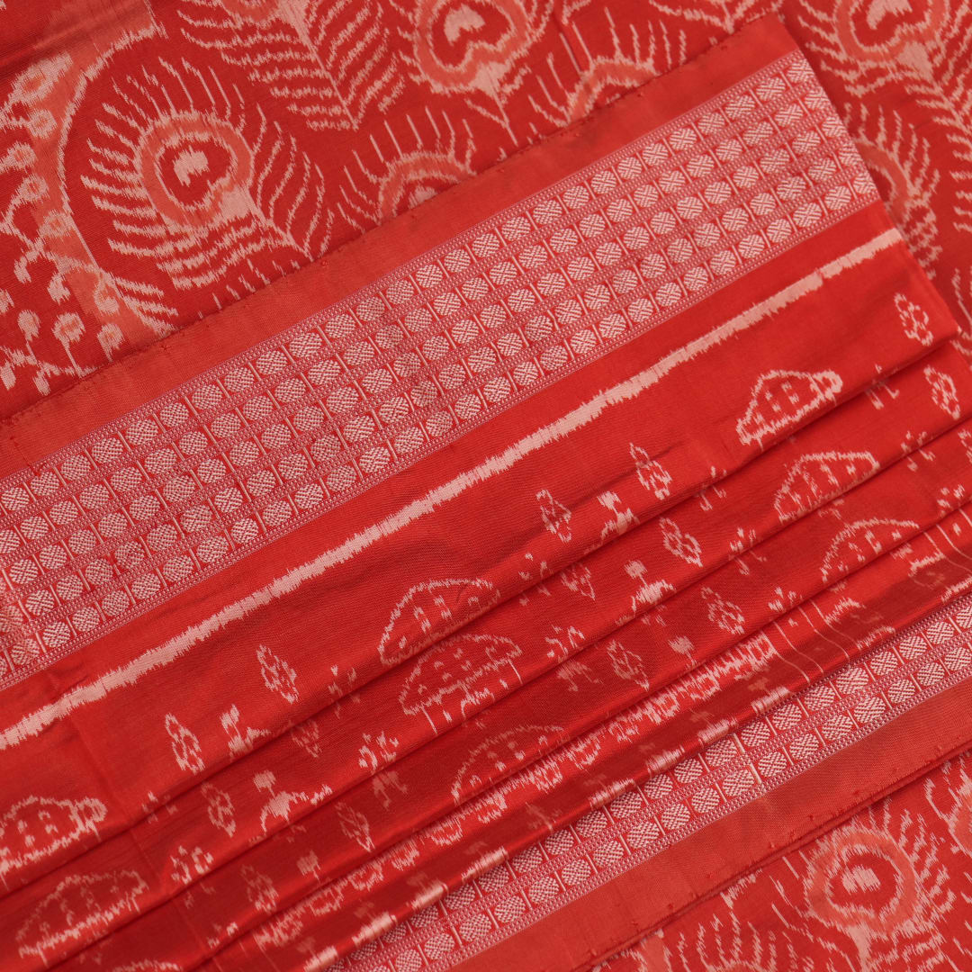 Close-up showcasing the intricately woven silk fabric texture of a multi-colored Sambalpuri saree with traditional motifs.