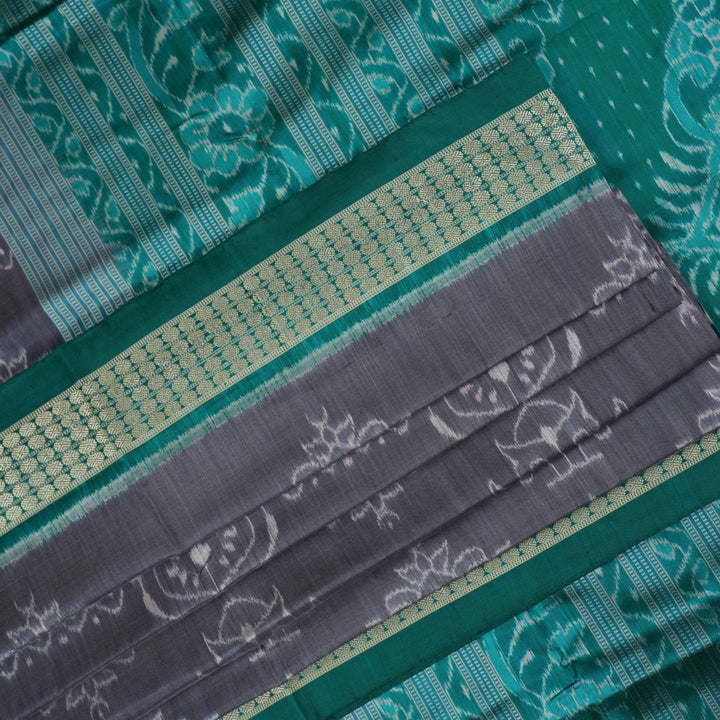 Extreme close-up of grey Sambalpuri silk fabric, revealing its fine handloom texture and weave quality.