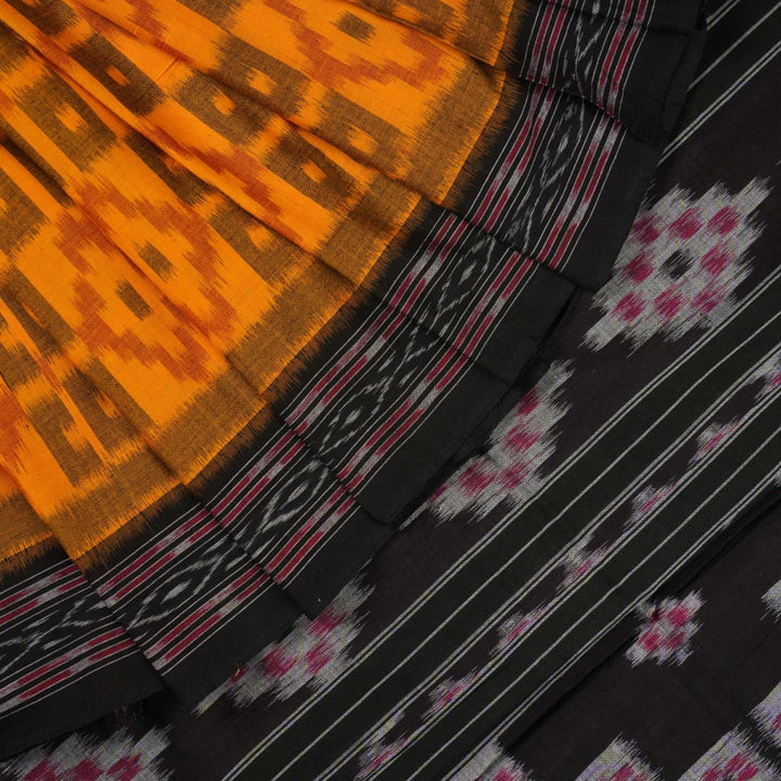 Professional styling of the yellow and black Sambalpuri cotton saree with traditional motifs shown on a model.